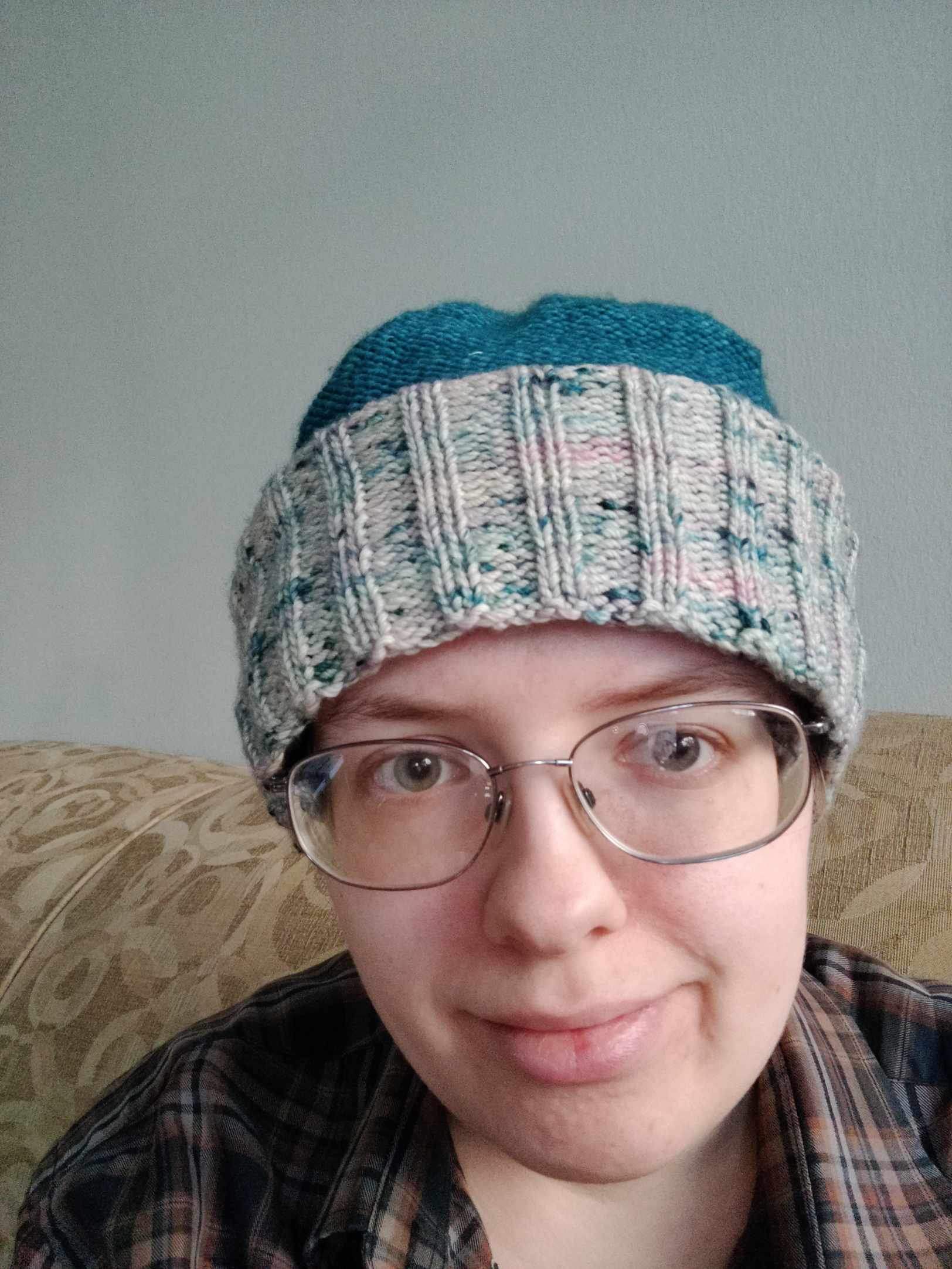 Emma wearing the balaclava rolled up, so it looks like an ordinary winter hat with a
turquoise body and a variegated brim.